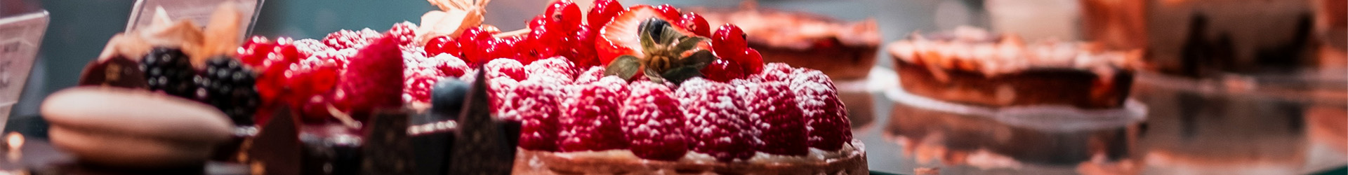 display of choclate cakes white berries on top